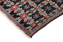 Backside of handmade 1950s Senneh rug showing knot structure and weave density