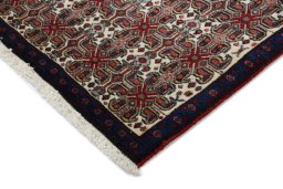 Backside of handmade 1960s Senneh rug showing knot structure and weave density