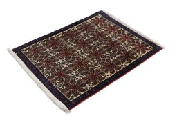 Corner detail of 1950s Senneh rug showing border pattern and Wool pile