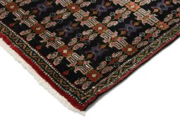 Backside of handmade 1950s Senneh rug showing knot structure and weave density