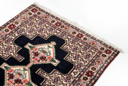 Surface texture of 1990s Senneh rug with natural Wool and intricate pattern