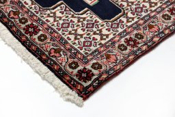 Backside of handmade 1990s Senneh rug showing knot structure and weave density