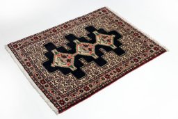 Corner detail of 1990s Senneh rug showing border pattern and Wool pile