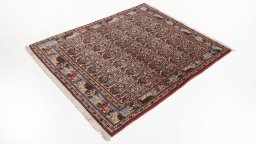 Corner detail of 1950s Senneh rug showing border pattern and Wool pile