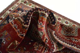 Corner detail of 2000s Shiraz rug showing border pattern and Wool pile