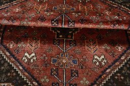 Corner detail of 2000s Shiraz rug showing border pattern and Wool pile