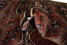 Corner detail of 2000s Shiraz rug showing border pattern and Wool pile