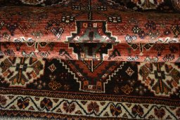 Corner detail of 2000s Shiraz rug showing border pattern and Wool pile