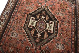 Backside of handmade 2000s Shiraz rug showing knot structure and weave density