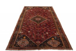 Surface texture of 2000s Shiraz rug with natural Wool and intricate pattern