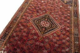 Backside of handmade 2000s Shiraz rug showing knot structure and weave density