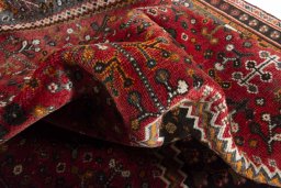 Corner detail of 2000s Shiraz rug showing border pattern and Wool pile