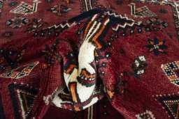 Corner detail of 2000s Shiraz rug showing border pattern and Wool pile