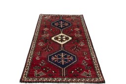 Surface texture of 2000s Shiraz rug with natural Wool and intricate pattern