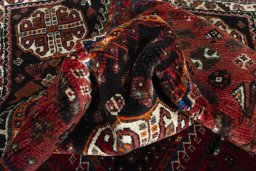 Corner detail of 2000s Shiraz rug showing border pattern and Wool pile