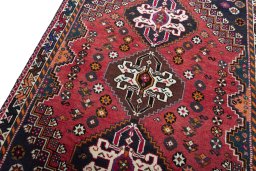 Backside of handmade 2000s Shiraz rug showing knot structure and weave density