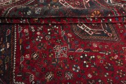 Corner detail of 2000s Shiraz rug showing border pattern and Wool pile