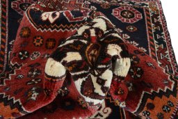 Corner detail of 2000s Shiraz rug showing border pattern and Wool pile