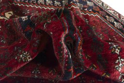 Corner detail of 2000s Shiraz rug showing border pattern and Wool pile