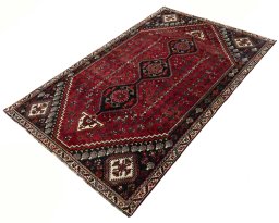 Corner detail of 2000s Shiraz rug showing border pattern and Wool pile