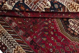 Corner detail of 2000s Shiraz rug showing border pattern and Wool pile
