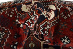 Corner detail of 2000s Shiraz rug showing border pattern and Wool pile