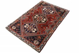 Corner detail of 2000s Shiraz rug showing border pattern and Wool pile