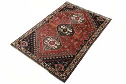 Corner detail of 2000s Shiraz rug showing border pattern and Wool pile