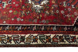Corner detail of 2000s Shiraz rug showing border pattern and Wool pile