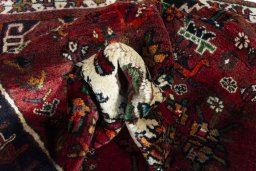 Surface texture of 2000s Shiraz rug with natural Wool and intricate pattern