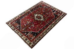 Corner detail of 2000s Shiraz rug showing border pattern and Wool pile