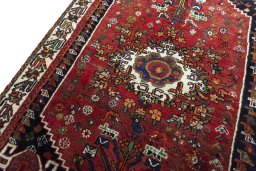 Backside of handmade 2000s Shiraz rug showing knot structure and weave density