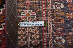 Backside of handmade 2000s Shiraz rug showing knot structure and weave density