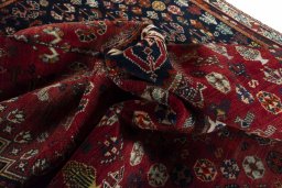 Backside of handmade 2000s Shiraz rug showing knot structure and weave density