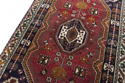 Backside of handmade 2000s Shiraz rug showing knot structure and weave density