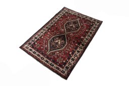 Corner detail of 2000s Shiraz rug showing border pattern and Wool pile