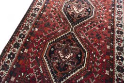 Backside of handmade 2000s Shiraz rug showing knot structure and weave density