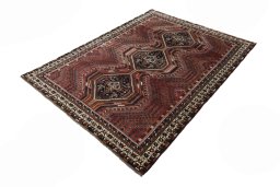 Corner detail of 2000s Shiraz rug showing border pattern and Wool pile