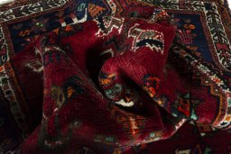 Corner detail of 2000s Shiraz rug showing border pattern and Wool pile