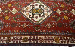 Corner detail of 2000s Shiraz rug showing border pattern and Wool pile