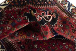 Corner detail of 2000s Shiraz rug showing border pattern and Wool pile