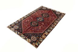 Corner detail of 2000s Shiraz rug showing border pattern and Wool pile