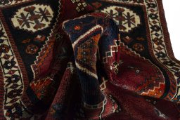 Corner detail of 2000s Shiraz rug showing border pattern and Wool pile