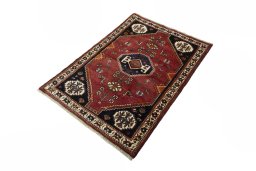 Corner detail of 2000s Shiraz rug showing border pattern and Wool pile