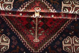 Corner detail of 2000s Shiraz rug showing border pattern and Wool pile