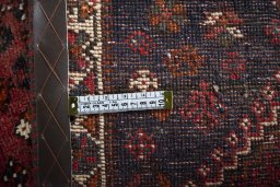 Surface texture of 2000s Shiraz rug with natural Wool and intricate pattern