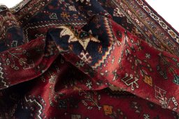 Corner detail of 2000s Shiraz rug showing border pattern and Wool pile