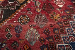 Corner detail of 2000s Shiraz rug showing border pattern and Wool pile