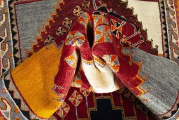 Corner detail of 2000s Shiraz rug showing border pattern and Wool pile