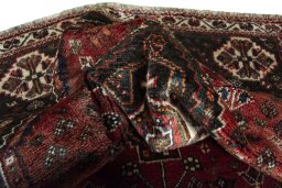 Corner detail of 2000s Shiraz rug showing border pattern and Wool pile